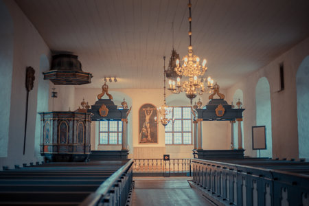 Historic church inside a medieval castle with wooden pews, stone walls, stained glass windows, and...