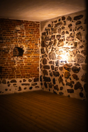 Old castle interior with antique furniture, stone walls, and warm light creating a medieval atmosphere full of history and mystery.の写真素材