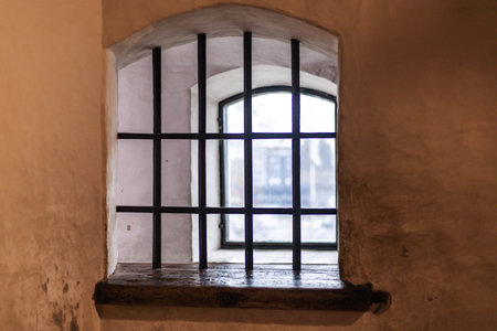 Old castle interior with antique furniture, stone walls, and warm light creating a medieval atmosphere full of history and mystery.の写真素材