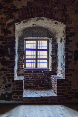 Old castle interior with antique furniture, stone walls, and warm light creating a medieval...