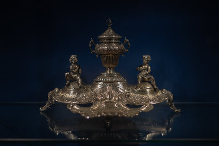 Various antique objects, including wooden chests, metal locks, sculptures, old books, and candle holders. Warm light emphasizes textures, historical craftsmanship, and atmosphere. Perfect for heritage, history, and interior photography.の写真素材