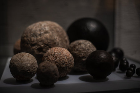 Various antique objects, including wooden chests, metal locks, sculptures, old books, and candle holders. Warm light emphasizes textures, historical craftsmanship, and atmosphere. Perfect for heritage, history, and interior photography.の写真素材