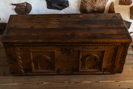 Old wooden chests with metal fittings placed in a medieval castle interior, showing antique craftsmanship, aged textures, and historical ambiance.の写真素材