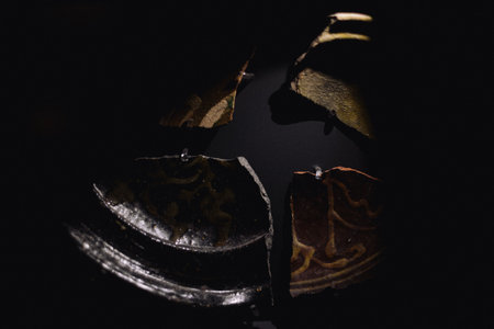 Various antique objects placed in a medieval castle interior, including wooden chests, metal locks, sculptures, old books, and candle holders. Warm light emphasizes textures, historical craftsmanship, and medieval atmosphere. Perfect for heritage, history, and interior photography.の写真素材