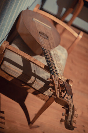 Various antique objects placed in a medieval castle interior, including wooden chests, metal locks, sculptures, old books, and candle holders. Warm light emphasizes textures, historical craftsmanship, and medieval atmosphere. Perfect for heritage, history, and interior photography.の写真素材