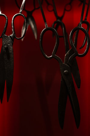 Various antique objects placed in an interior, including wooden chests, metal locks, sculptures, old books, and candle holders. Warm light emphasizes textures, historical craftsmanship, and atmospheric setting. Perfect for heritage, history, and interior photography.の写真素材