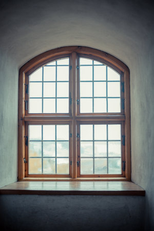 Old castle interior with antique furniture, stone walls, and warm light creating a medieval atmosphere full of history and mystery.の写真素材