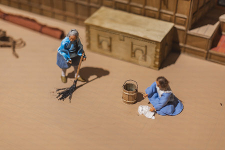 Miniature scenes inside a medieval castle showing figurines of knights, peasants, and nobles in daily life. Artistic staged display symbolizing history and craftsmanship.の写真素材