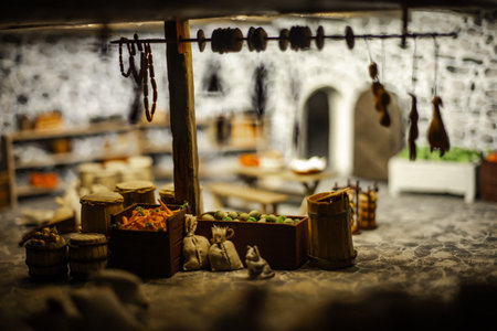 Miniature scenes inside a medieval castle showing figurines of knights, peasants, and nobles in daily life. Artistic staged display symbolizing history and craftsmanship.の写真素材