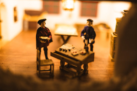 Miniature scenes inside a medieval castle showing figurines of knights, peasants, and nobles in daily life. Artistic staged display symbolizing history and craftsmanship.の写真素材