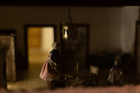 Miniature scenes inside a medieval castle showing figurines of knights, peasants, and nobles in daily life. Artistic staged display symbolizing history and craftsmanship.の写真素材