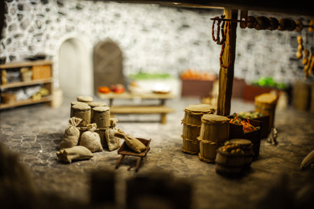Miniature scenes inside a medieval castle showing figurines of knights, peasants, and nobles in...