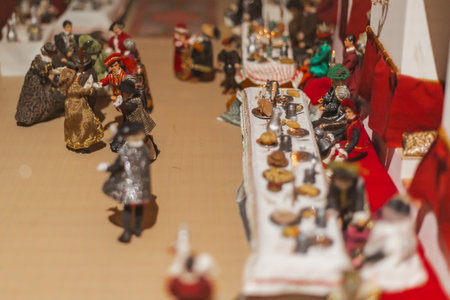 Miniature scenes inside a medieval castle showing figurines of knights, peasants, and nobles in daily life. Artistic staged display symbolizing history and craftsmanship.の写真素材