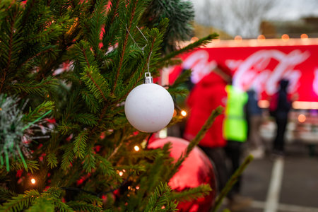 Photo of a Coca-Cola style red holiday truck decorated with festive lights in a snowy winter environment. Strong Christmas mood, iconic festive branding, and bright illuminated details.のeditorial素材