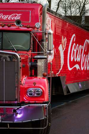 Photo of a Coca-Cola style red holiday truck decorated with festive lights in a snowy winter...