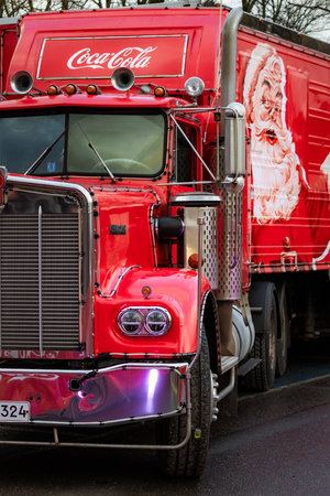 Photo of a Coca-Cola style red holiday truck decorated with festive lights in a snowy winter...
