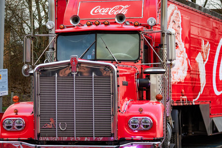 Photo of a Coca-Cola style red holiday truck decorated with festive lights in a snowy winter environment. Strong Christmas mood, iconic festive branding, and bright illuminated details.のeditorial素材