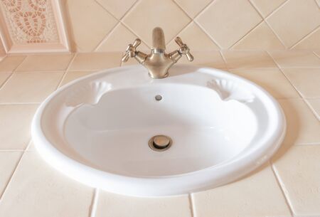 beautiful white sink with a bronze tapの写真素材