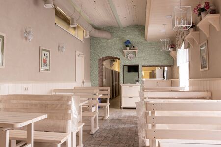 beautiful room furnished with tables and benchesの写真素材