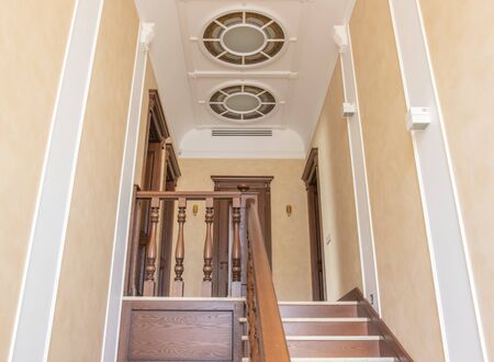 very beautiful ceiling closeup white and wooden staircaseの写真素材