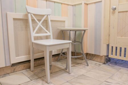 wooden and painted chair standing indoorsの写真素材