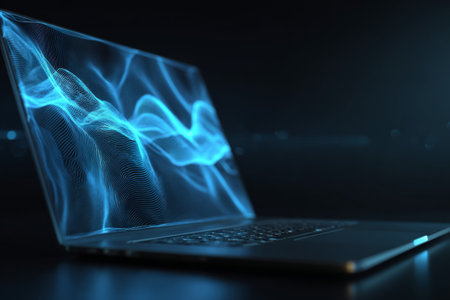 A laptop displays vibrant blue wave patterns, creating a captivating visual effect in a dark room. The setup highlights technology and modern design during nighttime.の素材