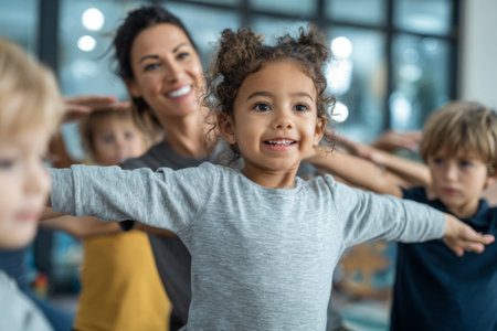 A group of children enjoys a lively dance class with a cheerful instructor. The kids are smiling and moving energetically in a bright and inviting studio space filled with natural light.の素材