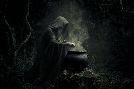 In a dark forest, a cloaked figure leans over a bubbling cauldron, surrounded by dense trees. Smoke rises as the figure carefully stirs, creating an eerie ambiance filled with mystery.の素材
