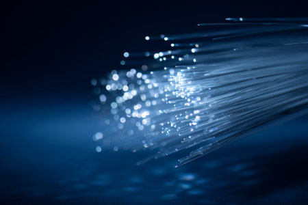 Bright light pulses emerge from fiber optic cables in a dark setting. The scene displays a captivating blend of colors and textures, revealing the beauty of advanced technology.の素材