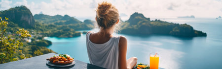 A person relaxes at a picturesque location, overlooking mountains and the ocean. They enjoy a delicious meal and a vibrant drink while taking in the tranquil scenery.の素材