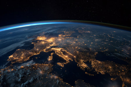 Bright city lights illuminate the landscape of Europe as seen from space. The image captures various regions, highlighting urban centers and coastlines. A stunning perspective of Earth at night.の素材