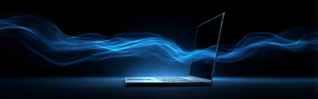 A sleek laptop sits against a dark background, emitting vibrant blue light waves. The scene conveys a sense of innovation and high-tech design in a minimalistic setting.の素材