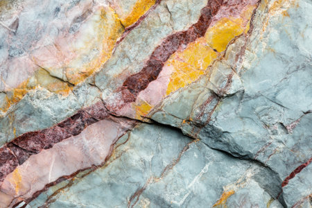 Rich natural stone features vibrant, multicolored mineral veins that create striking patterns. The detailed texture showcases unique geological formations.の素材