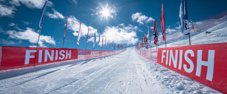 The ski racing course features a red finish banner and Norwegian flags in bright sunlight. This scene captures the excitement of the Nordic Ski World Championships on a clear day.の素材