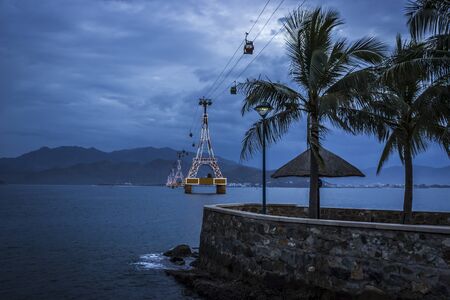 Asia, Vietnam, Nha Trang, Vinpearl. View from the coast of Vinpearl island to the cable car at duskの写真素材