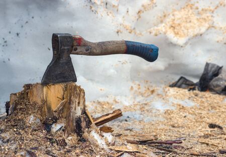 The working tool of the Siberian worker is an ax. The ax stuck in a stump during the lunch breakの写真素材