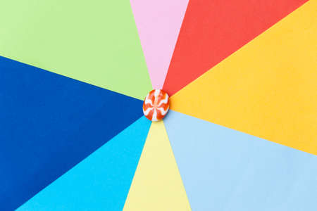Multicolored background with candy in the middle. Minimalism concept.