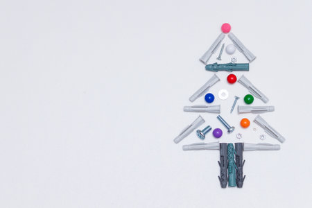 Christmas tree made of rapair tools, nuts, screws, dowels. Copy space.の写真素材