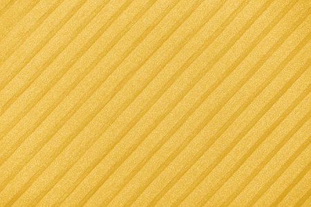 Plisse background. geometric cloth lines. Fabric, textile close up, toned in Fortuna Gold, color 2021の写真素材