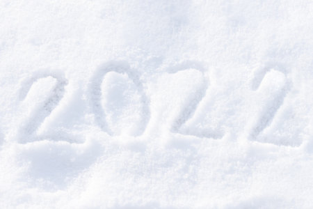 2022 written on the snow. Happy new year. Sunny winter day.の写真素材