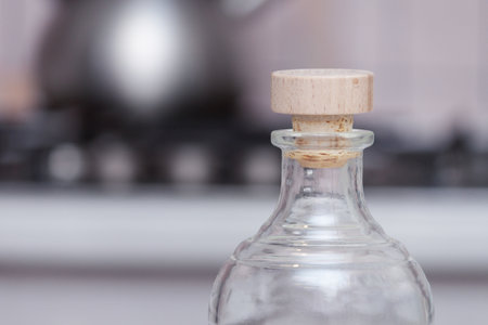 Transparent bottle with wooden cork in the kitchen.の写真素材