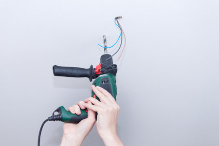 Electrician assembles electrical wiring for lampの写真素材