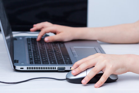 Left hander boy during online lessons at home, social distance during quarantine.の写真素材