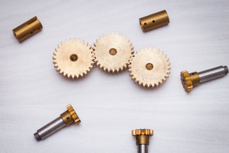 Engine metal gear wheels on wooden background.の写真素材