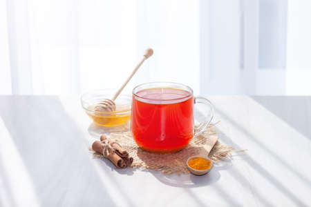 Turmeric tea with honey, cinnamon in the morning. Detox, healthy drink concept.の写真素材