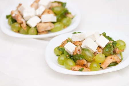 Tasty and healthy salad with feta cheese, grapes, chicken, arugula.の写真素材