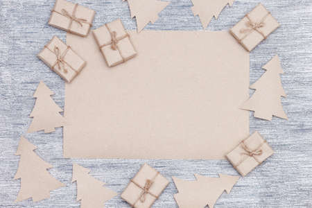 Christmas composition with empty clean craft paper. Christmas trees, gift boxes. Flat lay, top view. Wishes or goals concept for new year 2021の写真素材