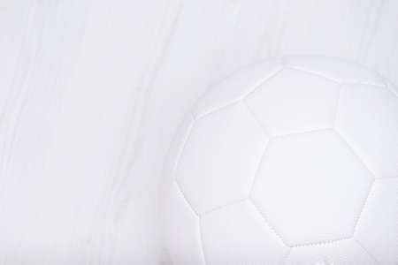 White soccer ball on white wooden background. Copy space. Over view.の写真素材