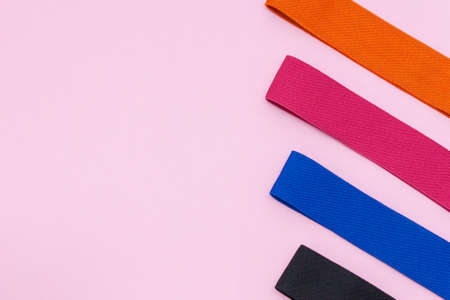A set of multi-colored elastic rubber bands for fitness on pink background. Fitness trend, sport concept.の写真素材
