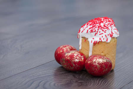 Easter Cakes or traditional Kulich, Paska, Bread with painted eggs on wooden background, empty copy...